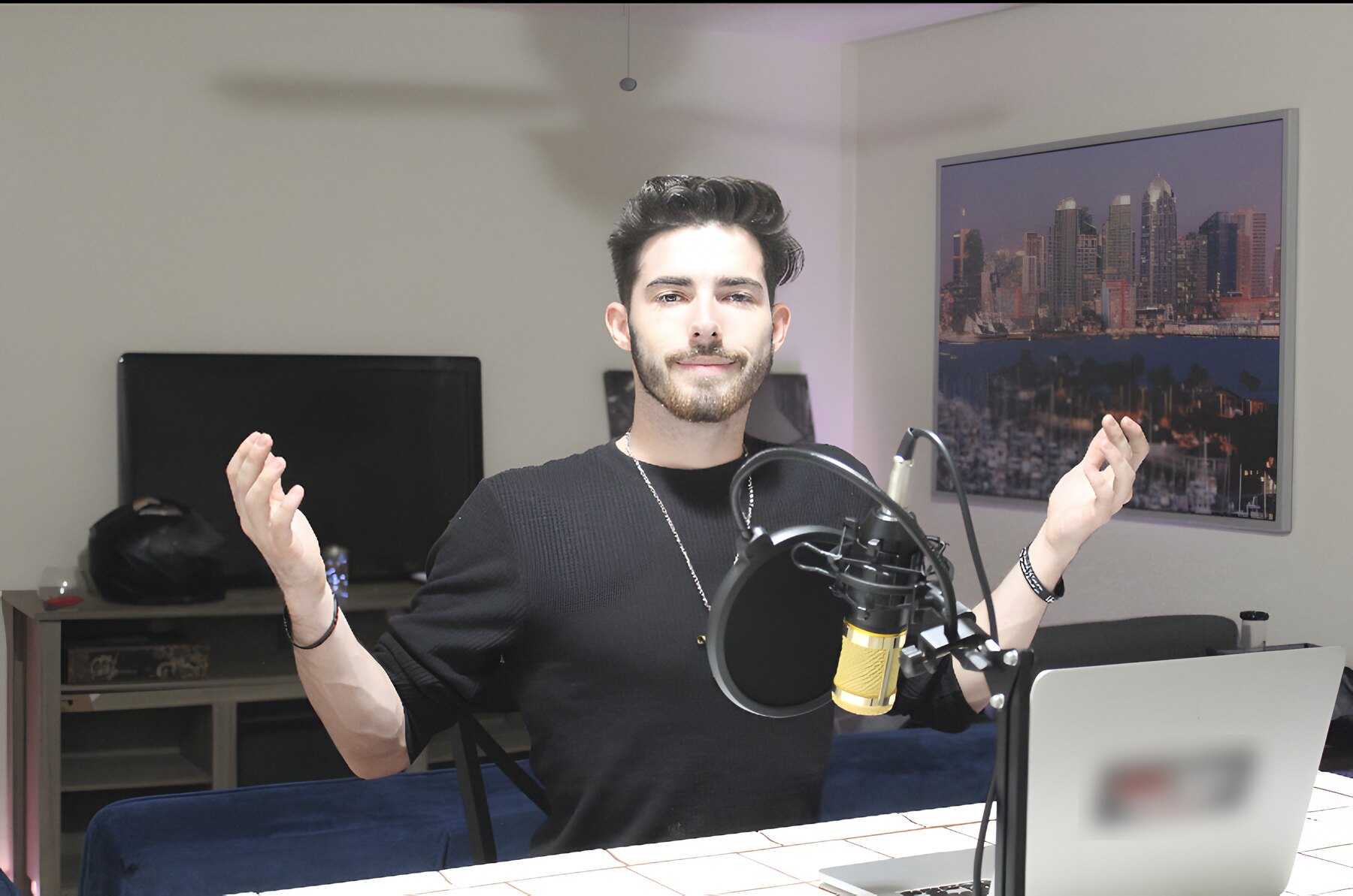 The founder at a microphone with arms open, explaining